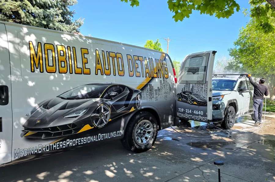 The Medina Brothers mobile detailing van parked at a customer's home in Pueblo